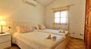 a bedroom with two beds and a window at Increible finca rustica con piscina in Selva +17 photos