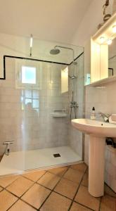 a bathroom with a glass shower with a sink and a sink at Increible finca rustica con piscina in Selva