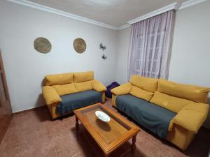 Posezení v ubytování Rincón de Joel Habitación con baño privado