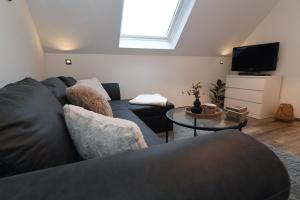 a living room with a couch and a tv at Apartment Am Stadtwald in Werne an der Lippe / NRW in Werne an der Lippe
