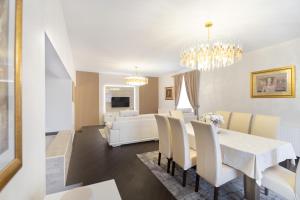 a dining room and living room with a white table and chairs at Monty in Pridraga