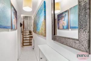 a hallway with paintings on the walls at Parea Living - Cosy 1-Bed Artistic Flat at Newington Green in London