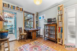 a room with a table and a book shelf at Parea Living - Cosy 1-Bed Artistic Flat at Newington Green in London