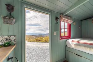 a bedroom with a window and a view of a road at Barlwyd Glamping in Blaenau-Ffestiniog