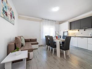 a living room with a couch and a table with chairs at Holiday Home Villa Vesna Lux in Zadar +39 photos