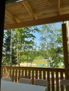 a screened in porch with a view of a park at Kodikas mökki lähellä luontoa Nurmijärven Perttulassa in Nurmijärvi
