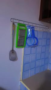 a kitchen counter with a spatula and a laptop on a shelf at L&A Homes in Kisii