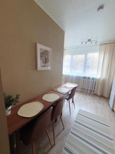 a dining room with three tables and chairs and a window at Airbnb Veriora in Veriora