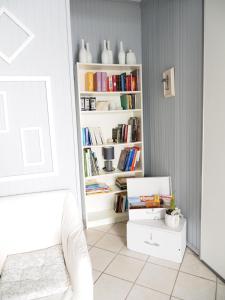 a room with a book shelf filled with books at La Mandragola Garden in Berra