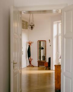 a white room with a mirror and a hallway at 4ry pokoje in Cieszyn