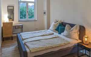a bedroom with a large bed with pillows on it at Stunning Apartment In Bad Heilbrunn in Bad Heilbrunn