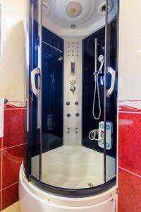 a shower with a glass door in a bathroom at Pansion Strossmayer in Osijek