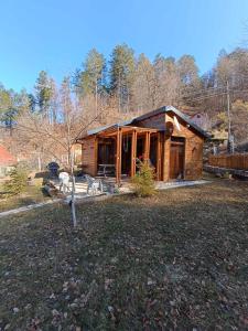 a log cabin in the middle of a yard at Wooden Mountain Villa in Berovo