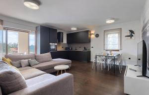 a living room and kitchen with a couch and a table at Villa-Venus in Višnjan
