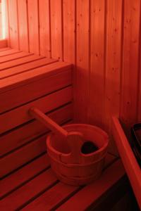 a red bucket sitting in a wooden sauna at 4ry pokoje in Cieszyn