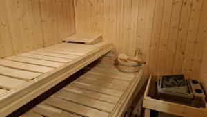 a inside of a sauna with a bucket in it at Appartement de vacances Les Jardins in Saint-Imier