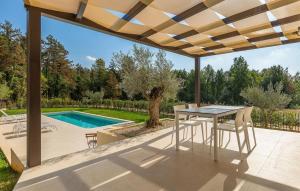 a patio with a table and chairs and a swimming pool at Villa-Vesta in Višnjan