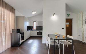 a kitchen and dining room with a table and chairs at Villa-Vesta in Višnjan