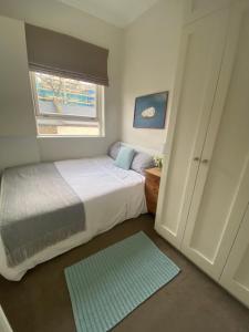 倫敦的住宿－Single Bedroom in Chelsea，一间小卧室,配有床和窗户