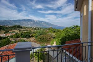 a balcony with a view of the ocean and mountains at Kazarma Luxury Apartment at Klismata village 8 guests in Spartià