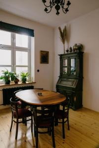 a dining room with a table and a piano at 4ry pokoje in Cieszyn
