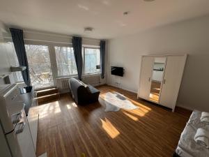 a living room with a couch and a chair at Berlinhome Apartment Steglitz in Berlin