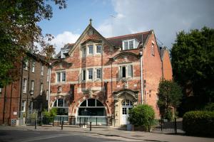 an old brick building with a large entrance at One Warwick Park Hotel in Royal Tunbridge Wells