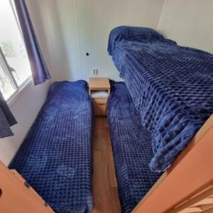 a couple of beds in a small room at MOBILE HOME COSY 4/5 personnes in Hyères