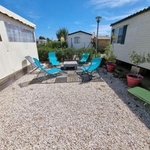 a group of chairs and a firepit in a backyard at MOBILE HOME COSY 4/5 personnes in Hyères