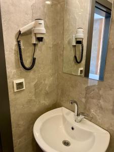 a bathroom with a sink and a phone on the wall at M-ODA OTEL in Antalya
