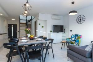 a dining room and living room with a table and chairs at Villa Tuta with heated pool, only 150 m from the beach in Pakoštane