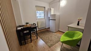 a small kitchen with a table and a refrigerator at Apartamente elegante in regim hotelier in Iaşi