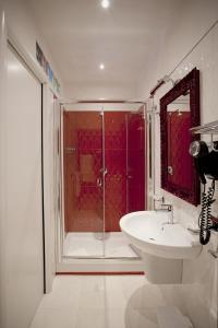 a bathroom with a glass shower and a sink at AP 2bd Mayfair in London