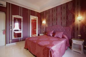 a bedroom with a pink bed and purple walls at AP 2bd Mayfair in London