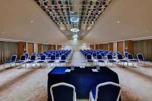 a conference room with blue chairs and a table in the middle at Antarim Express in Bharuch