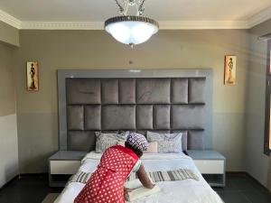 a young child is jumping on a bed at MATOLA AcCOMMODATION in Matola