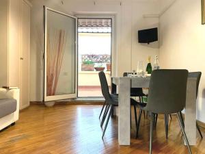 a dining room with a table and chairs in a room at Cozy Terrace Rome Termini in Rome