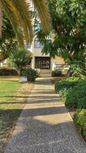 a walkway in front of a building with trees at Resort Apartment Cabanas de Tavira in Tavira