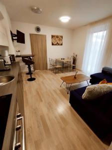 a living room with a couch and a table at Beach Home Apartman in Balatonfüred +15 photos
