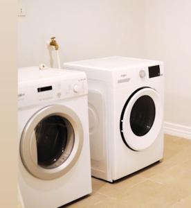a white washing machine next to a washer at Trillo Bay Villas in Kababae