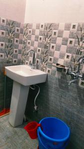 łazienka z umywalką i niebieskim wiadrem w obiekcie Rivulet Resort & Camping w mieście Mussoorie