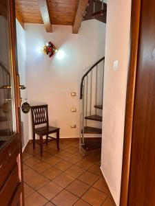 a hallway with a stair case and a chair at B&B L'Infiorescenza new in Siracusa