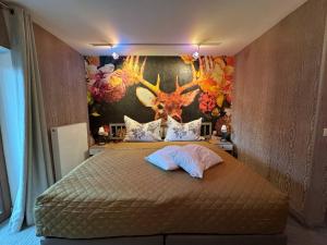 a bedroom with a bed with a deer head on the wall at Two Brothers Inn in Pertisau