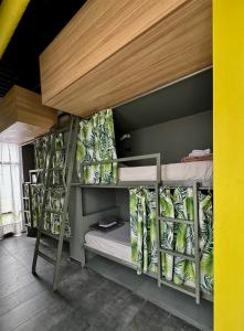 a bunk bed with three bunk beds in a room at Iconic Athens Hostel in Athens