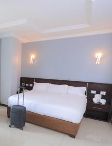 a bedroom with a bed with a suitcase at East Gate Appartement Gust House in Addis Ababa