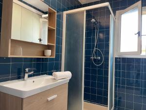 a blue tiled bathroom with a sink and a shower at Villa de Charme au coeur du Cap-Ferrat in Saint-Jean-Cap-Ferrat +35 photos