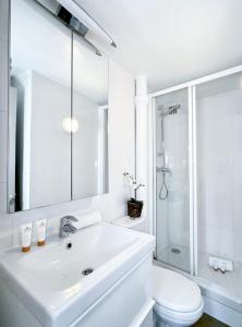 a white bathroom with a sink and a toilet at 841 - Panthéon chic in Paris Olympic Games 2024 in Paris