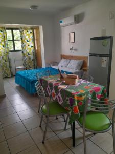a room with a table and chairs and a bed at Alojamiento Lavalle in Guaymallen