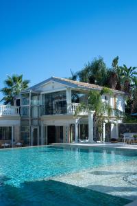 Una casa grande con piscina delante de ella. en Thalos boutique home, en Augusta