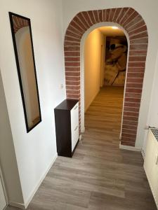 a hallway with an archway and a dresser in a room at Villa Emi in Lutherstadt Eisleben